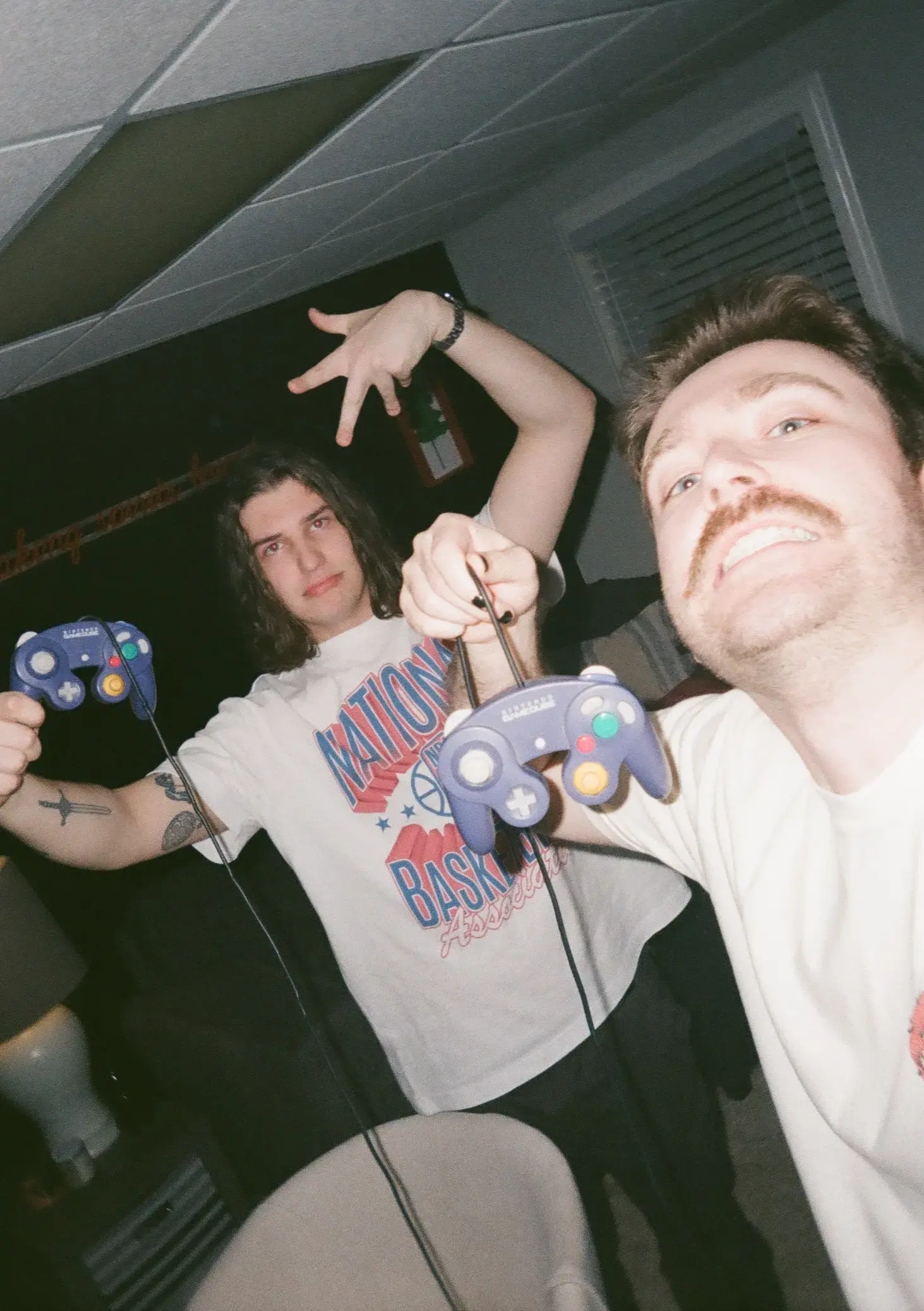 Me and my brother-in-law holding up Gamecube controllers